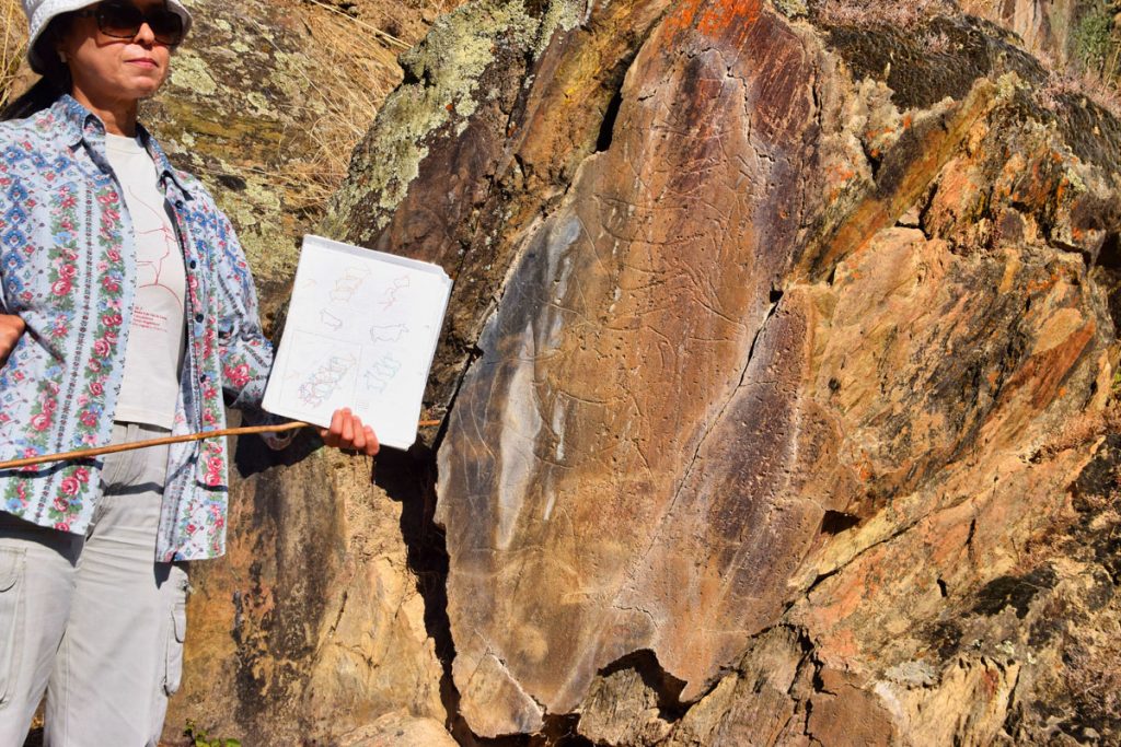 Our Guide Points Out The Paleolithic Carvings